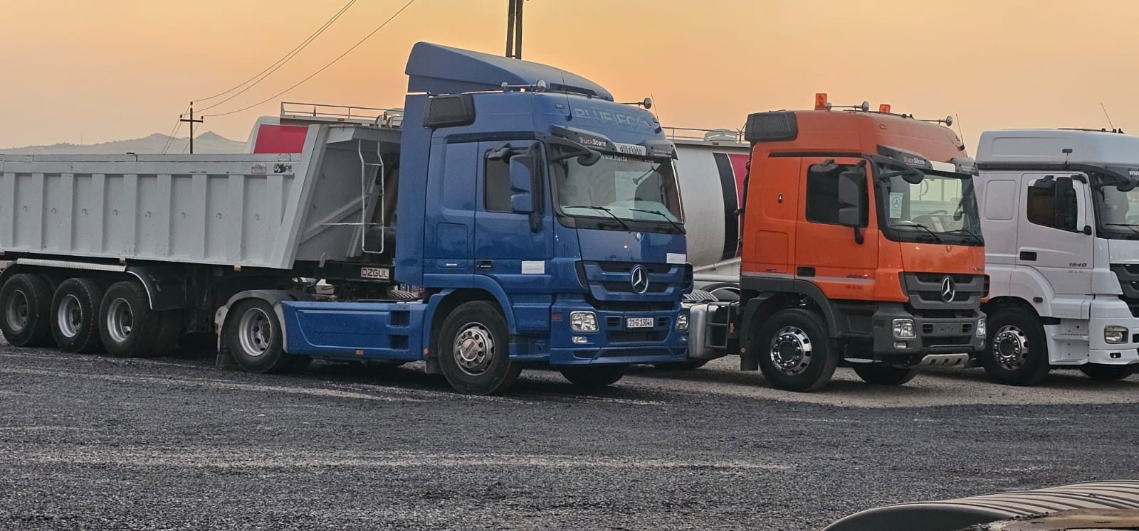Company tipper units at the yard at dusk